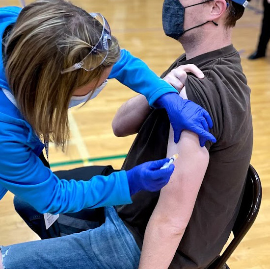An employee receives the vaccine