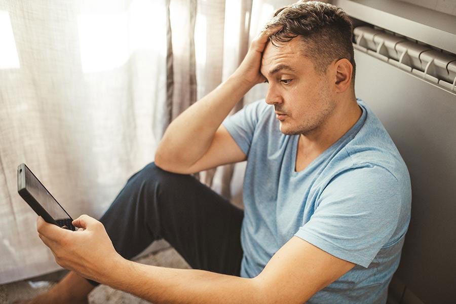 A man looking on a phone